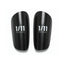 Pair of black shin guards with '1/11 Football' branding on a white background